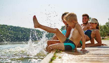 Kinder spielen am Wasser.