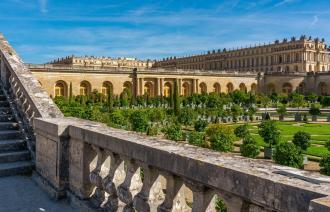Schloss Versaille in Frankreich, man schaut von einer Erhöhung über den Garten zum Schloss.