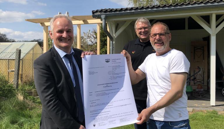 Der Potsdamer Holger Reissing erweitert die Photovoltaikanlage auf seinem Carport und erhält dafür 2.000 Euro aus dem Potsdamer Klimafonds. Bernd Rubelt und Norbert Lange überreichen den Zuwendungsbescheid.